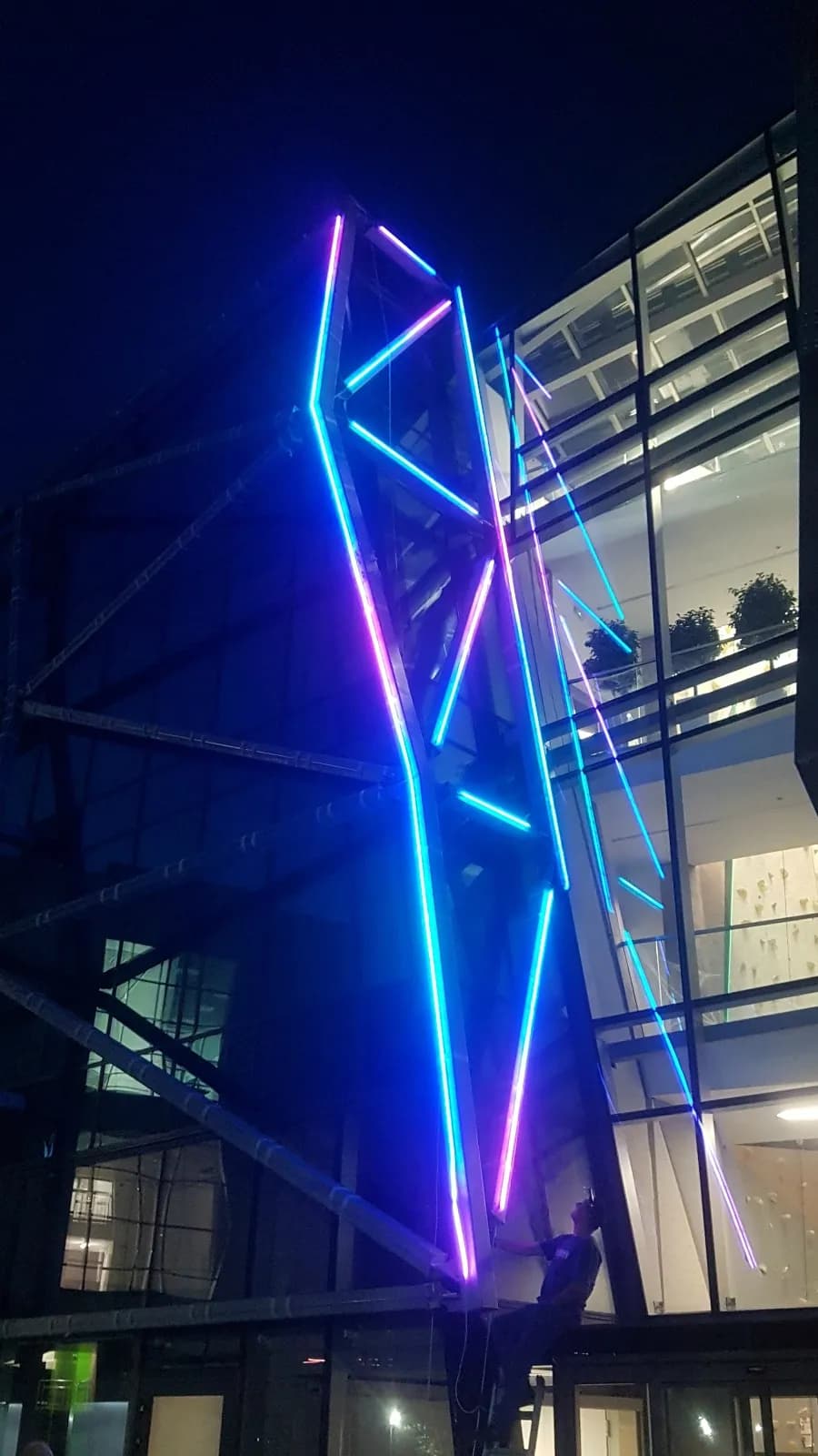 E-Walls LED strips used as building lighting system during nighttime and glowing in blue