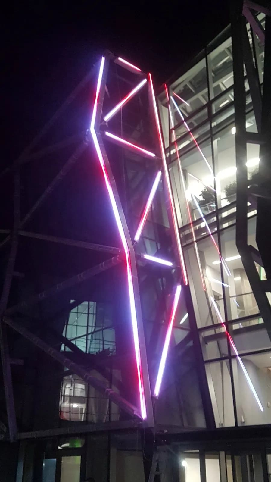 E-Walls LED strips used as building lighting system during nighttime and glowing in red