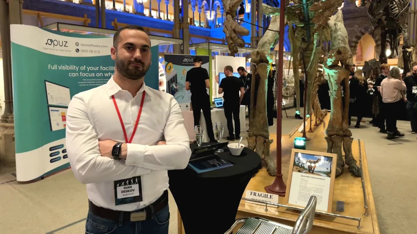 Dian Deskov`s hand holding the brochure of Opuz Compliance Software with his hand visible in the borchure
